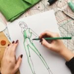top-view-on-woman-designer-drawing-clothes-sketches-e1649869837824-pnbbkxrfg73u7c7ht3egbdz9c6ars1vadlu39y8x00